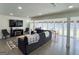 Bright living room with a large sectional, fireplace, TV, wood floors, and many windows at 20 Rosser Rd, Mcdonough, GA 30252