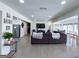Open-concept living room with hardwood floors, a large sectional sofa, and a view of the kitchen at 20 Rosser Rd, Mcdonough, GA 30252