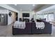 Open concept living room with hardwood floors, dark sectional sofa, and a view of the kitchen area at 20 Rosser Rd, Mcdonough, GA 30252