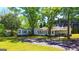 Spacious home featuring a charming sunroom addition, set amongst mature trees with a long driveway at 20 Rosser Rd, Mcdonough, GA 30252