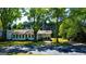 Charming home nestled among mature trees with a long, shaded driveway and a welcoming front porch at 20 Rosser Rd, Mcdonough, GA 30252