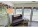 Bright sitting area featuring lots of natural light and a cozy loveseat by multiple windows at 20 Rosser Rd, Mcdonough, GA 30252