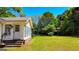 Bright sunroom with windows, door, steps, and a lush yard beyond providing ample natural light and outdoor access at 20 Rosser Rd, Mcdonough, GA 30252