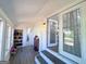 Inviting sunroom with shoe rack and access to the laundry room at 20 Rosser Rd, Mcdonough, GA 30252