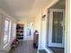 Inviting sunroom features natural light, a built-in shoe rack, and access to the laundry room at 20 Rosser Rd, Mcdonough, GA 30252