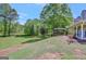 Expansive backyard featuring a well-maintained lawn and a covered patio at 40 Butler Bridge Dr, Mcdonough, GA 30252