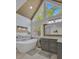 Bright bathroom featuring a soaking tub, wooden ceiling, and a large window at 40 Butler Bridge Dr, Mcdonough, GA 30252
