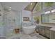 Modern bathroom features a glass shower, soaking tub, and vaulted ceiling at 40 Butler Bridge Dr, Mcdonough, GA 30252