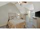 Cozy bedroom featuring sloped ceilings, neutral tones, and a ceiling fan, offering a relaxing retreat at 40 Butler Bridge Dr, Mcdonough, GA 30252