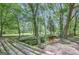 Scenic creek view with log bridge surrounded by lush green trees and foliage at 40 Butler Bridge Dr, Mcdonough, GA 30252