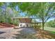 Home exterior with a covered area, an open deck, and mature trees at 40 Butler Bridge Dr, Mcdonough, GA 30252