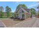 Exterior view of a charming gray home with a covered porch and a long gravel driveway at 40 Butler Bridge Dr, Mcdonough, GA 30252