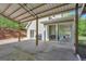 Spacious covered patio area attached to a house with an additional expansive concrete pad and gravel driveway at 40 Butler Bridge Dr, Mcdonough, GA 30252