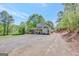 Wide angle shot of a charming gray home with a long driveway and lush greenery at 40 Butler Bridge Dr, Mcdonough, GA 30252