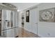 Hallway view featuring wood floors, white trim, and a stainless steel refrigerator at 40 Butler Bridge Dr, Mcdonough, GA 30252