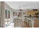 Bright kitchen with a breakfast bar, access to the backyard, and stylish pendant lighting at 40 Butler Bridge Dr, Mcdonough, GA 30252