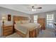 A cozy main bedroom with a ceiling fan and matching wood furniture at 40 Butler Bridge Dr, Mcdonough, GA 30252