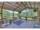 Relax in the spacious pavilion with ceiling fans, comfortable seating, and scenic views of the lush backyard at 40 Butler Bridge Dr, Mcdonough, GA 30252