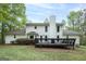 A home's rear facade is displayed with a large deck and chimney at 173 Darwish Dr, Mcdonough, GA 30252