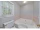 Bathroom features a jacuzzi tub and a large window offering natural light at 173 Darwish Dr, Mcdonough, GA 30252