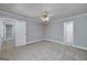 Spacious bedroom with neutral carpet, overhead lighting and hallway access at 173 Darwish Dr, Mcdonough, GA 30252