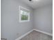 Bedroom features neutral carpet, a window with blinds, and a light gray painted wall at 173 Darwish Dr, Mcdonough, GA 30252