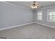 Carpeted bedroom with multiple windows and ceiling fan at 173 Darwish Dr, Mcdonough, GA 30252