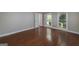 Bright bedroom with hardwood floors, two windows, and neutral wall colors at 173 Darwish Dr, Mcdonough, GA 30252