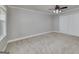 Spacious bedroom featuring neutral carpet, a ceiling fan with lighting, and closet with double doors at 173 Darwish Dr, Mcdonough, GA 30252