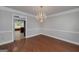 Spacious dining room featuring hardwood floors, crown molding, and a decorative chandelier at 173 Darwish Dr, Mcdonough, GA 30252