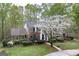 Aerial view of beautiful brick home surrounded by mature trees and landscaped lawn at 173 Darwish Dr, Mcdonough, GA 30252