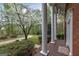 Home's porch lined with columns shows landscaped yard and a mature dogwood tree at 173 Darwish Dr, Mcdonough, GA 30252