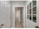 Hallway with tile floors leading to a bathroom and access to the garage at 173 Darwish Dr, Mcdonough, GA 30252