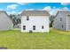 Expansive backyard with healthy, green grass. New homes are visible on either side of the yard at 295 Limestone Circle, Conyers, GA 30013