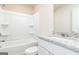 A clean, all-white bathroom features granite countertop, bath with built in shelves, and brushed fixtures at 295 Limestone Circle, Conyers, GA 30013