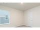 Bright bedroom features a light filled window and neutral walls and carpet at 295 Limestone Circle, Conyers, GA 30013