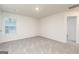 Bedroom featuring neutral carpet, a window, and an interior door at 295 Limestone Circle, Conyers, GA 30013