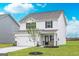 New construction home featuring a two-car garage, charming front yard, and neutral color scheme at 295 Limestone Circle, Conyers, GA 30013