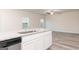 Bright kitchen island with granite countertops and stainless steel sink at 295 Limestone Circle, Conyers, GA 30013