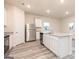 Kitchen featuring stainless steel appliances, a central island, and luxury vinyl tile flooring at 295 Limestone Circle, Conyers, GA 30013