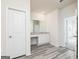 Bathroom showcasing a white vanity with a mirror and a doorway leading to another room at 299 Limestone Circle, Conyers, GA 30013
