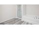 Modern bathroom features a glass-enclosed shower and a separate soaking tub for a relaxing experience at 299 Limestone Circle, Conyers, GA 30013