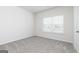 Bedroom with new gray carpet, a window for natural light, and neutral paint at 299 Limestone Circle, Conyers, GA 30013