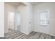 Entryway with wood-look floors, white walls, trim, and doors leading to various rooms at 299 Limestone Circle, Conyers, GA 30013