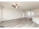 Open-concept living room with plenty of natural light, wood-look floors, and a ceiling fan at 299 Limestone Circle, Conyers, GA 30013