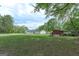 Large backyard showcasing the home and various outbuildings on the property at 395 Moss Ferry Rd, Villa Rica, GA 30180