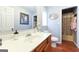 Bright bathroom features a white vanity with an undermount sink and access to the shower and toilet at 395 Moss Ferry Rd, Villa Rica, GA 30180