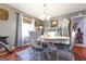 Traditional dining room features hardwood flooring and wainscoting with views of the backyard at 395 Moss Ferry Rd, Villa Rica, GA 30180