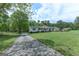 Ranch style home with covered entry and long driveway on expansive lawn at 395 Moss Ferry Rd, Villa Rica, GA 30180