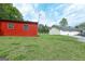 The outbuilding sits on a spacious lawn alongside the main house with a two-car garage at 395 Moss Ferry Rd, Villa Rica, GA 30180